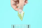 female hand dipping filled blate pape into water