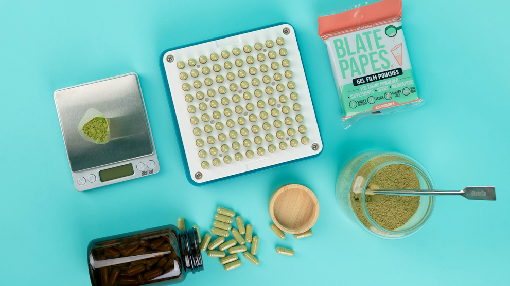 Capsule making machine with digital scale, green supplement powder and empty capsules