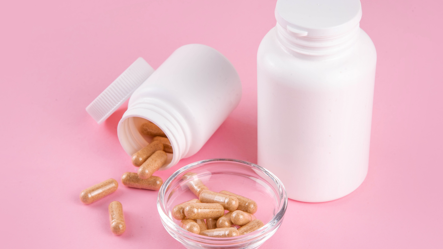 Supplement capsules and bottles symbolizing building your own supplement brand