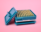 Teal capsule filler with completed capsules sitting inside of it #color_teal