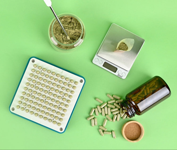 Herbal products including a jar, scale, and container on a green background